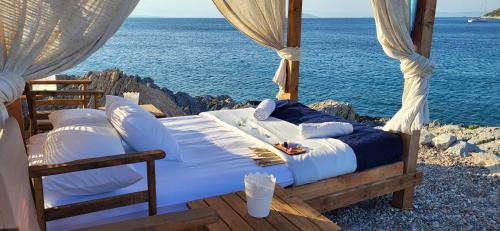 a bed with a view of the ocean at Aponisos island in Megalochori