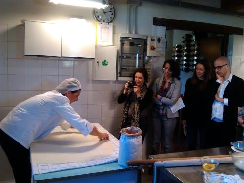 a woman standing in a kitchen preparing food at Country House Casco Dell'Acqua in Trevi