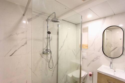 a bathroom with a shower and a toilet and a mirror at FLC-PANIER- OLD PORT 500m - T3- 2 Bedrooms -Maxi 6 Guests in Marseille