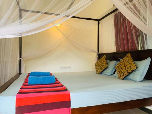 a bedroom with a bed in a tent at Deshan Homestay & Restaurant in Tangalle