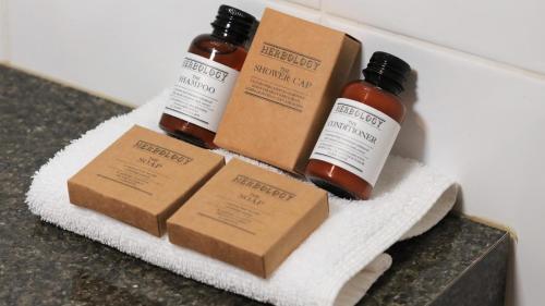 three bottles of essential oils sitting on a towel at Ashton Motel in Tumut
