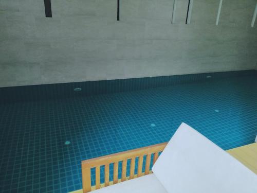 a room with a blue tile floor and a table at Sukhumvit​ 101 in Phra Khanong