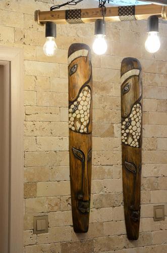 two wooden totem poles hanging on a wall at Апартамент Девио in Ruse