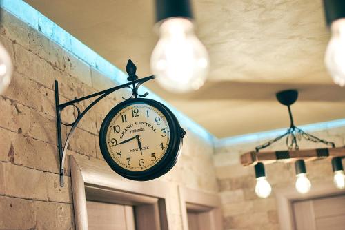 a clock is attached to a brick wall at Апартамент Девио in Ruse