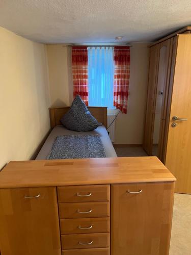 a small bedroom with a bed and a dresser at Schönes Ferienhaus in Braubach in Braubach