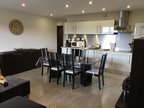 a kitchen and dining room with a table and chairs at Gîte chez Laurence in Les Fins