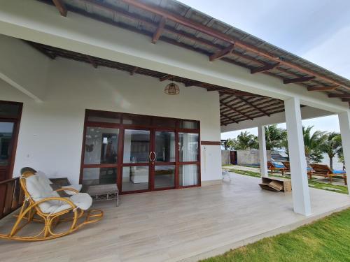 a porch of a house with a rocking chair at Myhoa Lagoon - Kiting Town in Phan Rang