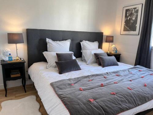 une chambre avec un grand lit avec des fleurs rouges dessus dans l'établissement Le Victoria - Confort, au Havre