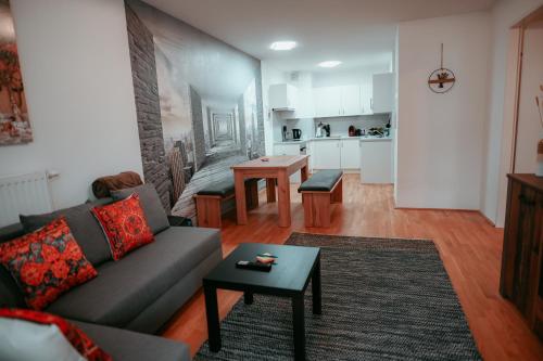 a living room with a couch and a table at Vienna Cozy Apartment 105 in Vienna