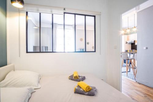 - une chambre blanche avec un lit et 2 serviettes dans l'établissement Happy Trip - Hypercentre, au Havre