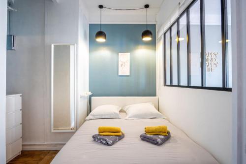 - une chambre avec 2 lits dotés d'oreillers jaunes dans l'établissement Happy Trip - Hypercentre, au Havre