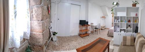 a living room with a couch and a table at A casa do Santo in Pontevedra