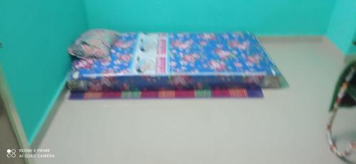 a pile of ties sitting on top of a rug at KEERTHISH NIVAS Home stay in Tiruvannāmalai