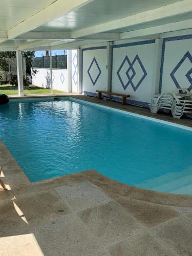 a large swimming pool with blue water at Villa Abreu in Esposende