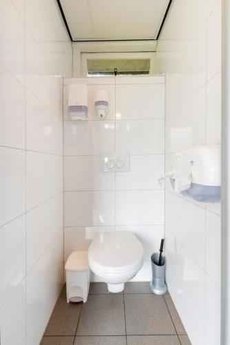 uma casa de banho branca com um WC e um lavatório em Bell Tent em Warmond