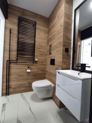 a bathroom with a white toilet and a sink at ***Santorini Apartament*** - 40m² ✓ in Rybnik