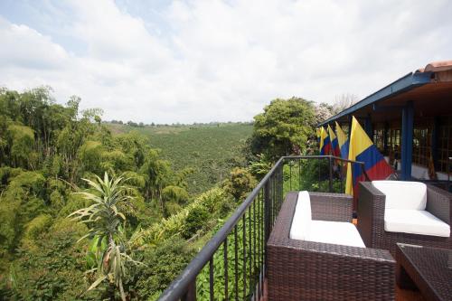 a balcony of a house with a view of the jungle at Finca Hotel Los Girasoles in Montenegro