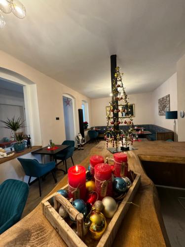 a living room with a christmas tree and a table at Aneton Garni Hotel in Thale