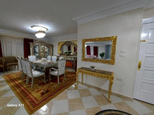 uma sala de jantar com uma mesa e um espelho em Deluxe Apartment Nasr city no Cairo