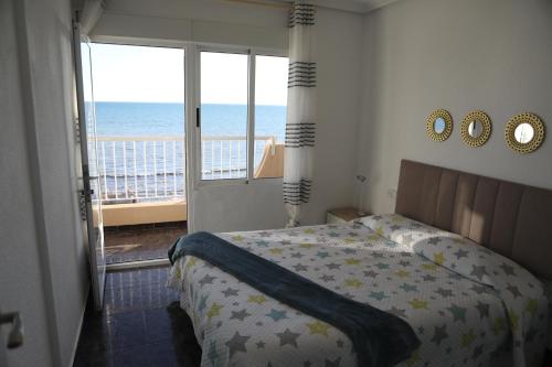 a bedroom with a bed and a view of the ocean at Vista Bonita - Beautiful View!!! in Santa Pola