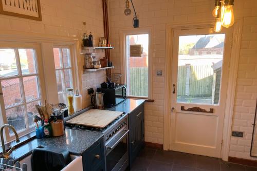 a kitchen with a stove and a counter top at 1880s Soap Worker's Cottage, Port Sunlight in Port Sunlight