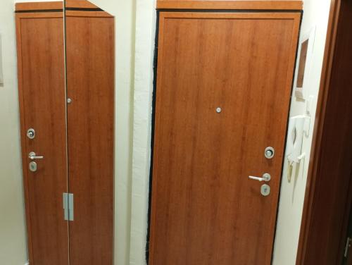 two wooden doors are next to each other at Nikou Nikolaou Apartment in Serres