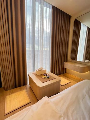 a bedroom with a bed and a large window at Wawa Guesthouse Pollux Habibie Batam Tower A 18 in Batam Center