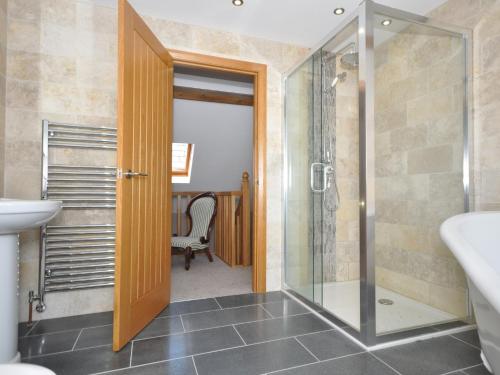 a bathroom with a shower and a glass door at 2 bed in Abergavenny 65965 in Pandy