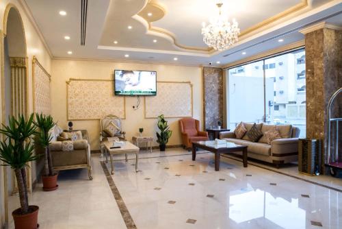 a lobby with couches and a flat screen tv at سارا للشقق الفندقية Sara Furnished Apartments in Al Khobar