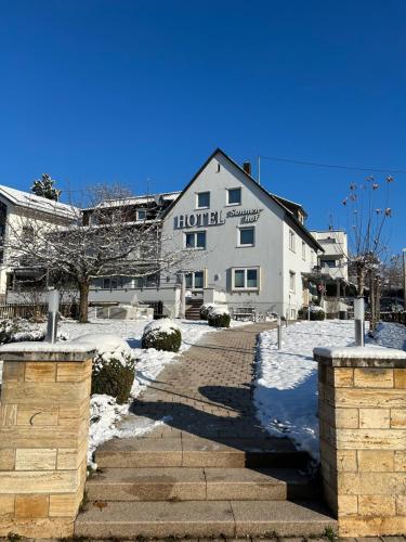 a hotel building with snow on the ground at Hotel Sonnenhof in Sindelfingen