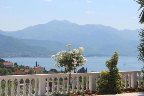 a white fence with a view of the water at Elegance Duplexes by Monte Aria in Herceg-Novi