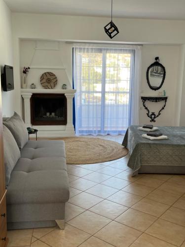 a living room with a couch and a fireplace at Elefanti Nani in Livadia
