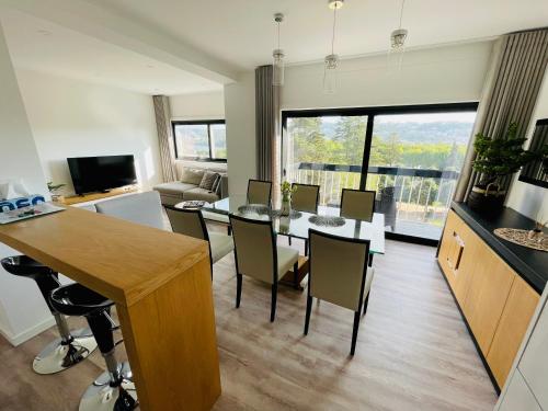 a kitchen and living room with a table and chairs at Top View Apt at Historical Center in Coimbra