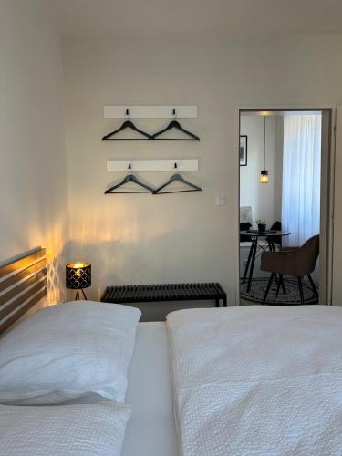 a bedroom with a white bed and a living room at Morava apartmán Uherské Hradiště Šafaříkova 855 in Uherské Hradiště
