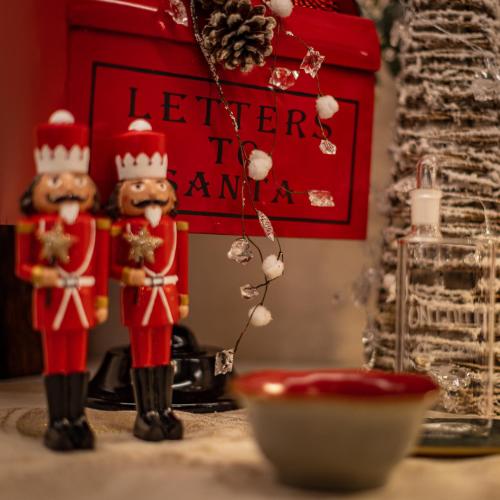 a couple of nutcracker figurines on a table at PALAZZO DEL CAPITANO Wellness & Relais - Luxury Borgo Capitano Collection in San Quirico dʼOrcia