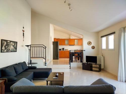 a living room with a couch and a table at Aurora Family Loft in Nafplio