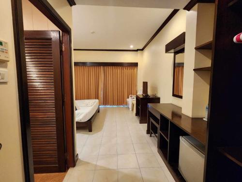 a room with a bedroom with a bed and a room with at Baan Kingkeaw Thamdee Patong in Patong Beach