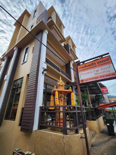 a building with a sign in front of it at Baan Kingkeaw Thamdee Patong in Patong Beach