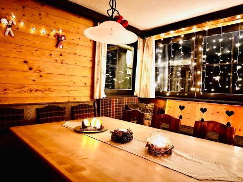 a dining room table with candles on it with lights at Fleissner Hütte in Innerkrems