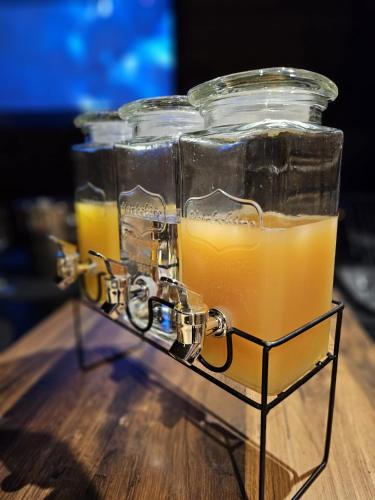 two glass jars filled with orange juice on a table at Le Chalet Loft Spa in Calais