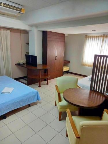 a hotel room with a bed and a table and chairs at Bella B PLUS เบลล่า บี พลัส in Bangkok