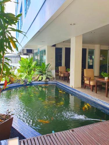 a pool in the middle of a building at Bella B PLUS เบลล่า บี พลัส in Bangkok