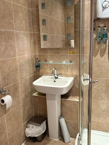 a bathroom with a sink and a shower at The Swan Inn Salisbury in Wilton