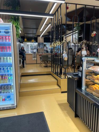 a store aisle of a store with drinks and food at Nani City Hotel in Zurich