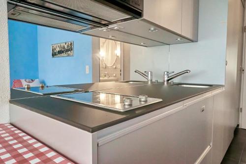 a kitchen with a sink and a counter top at Lake apartment by Interlaken in Därligen