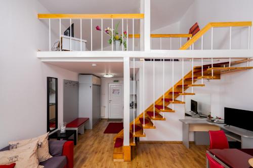a room with a staircase and a living room at Casa Augsburg in Băneşti