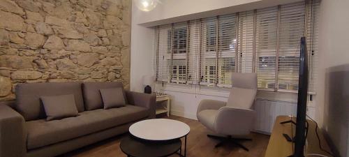 a living room with a couch and two chairs at Calle Real con patio in Ferrol