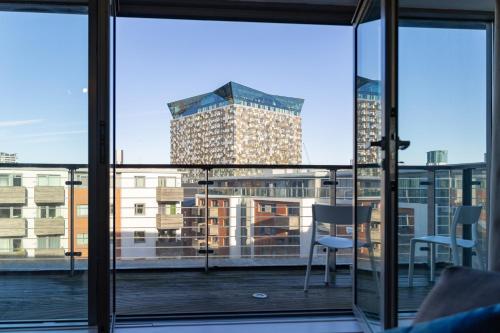 a balcony with a view of a tall building at Penthouse City Centre - Luxury Apartment in Birmingham