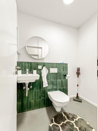 a bathroom with a toilet and a sink at Modern living: Hamburg & Baltic Sea within 30 min in Ahrensburg