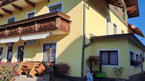 a yellow and green building with a balcony at Almgasthof Spitzer in Sankt Stefan ob Leoben
